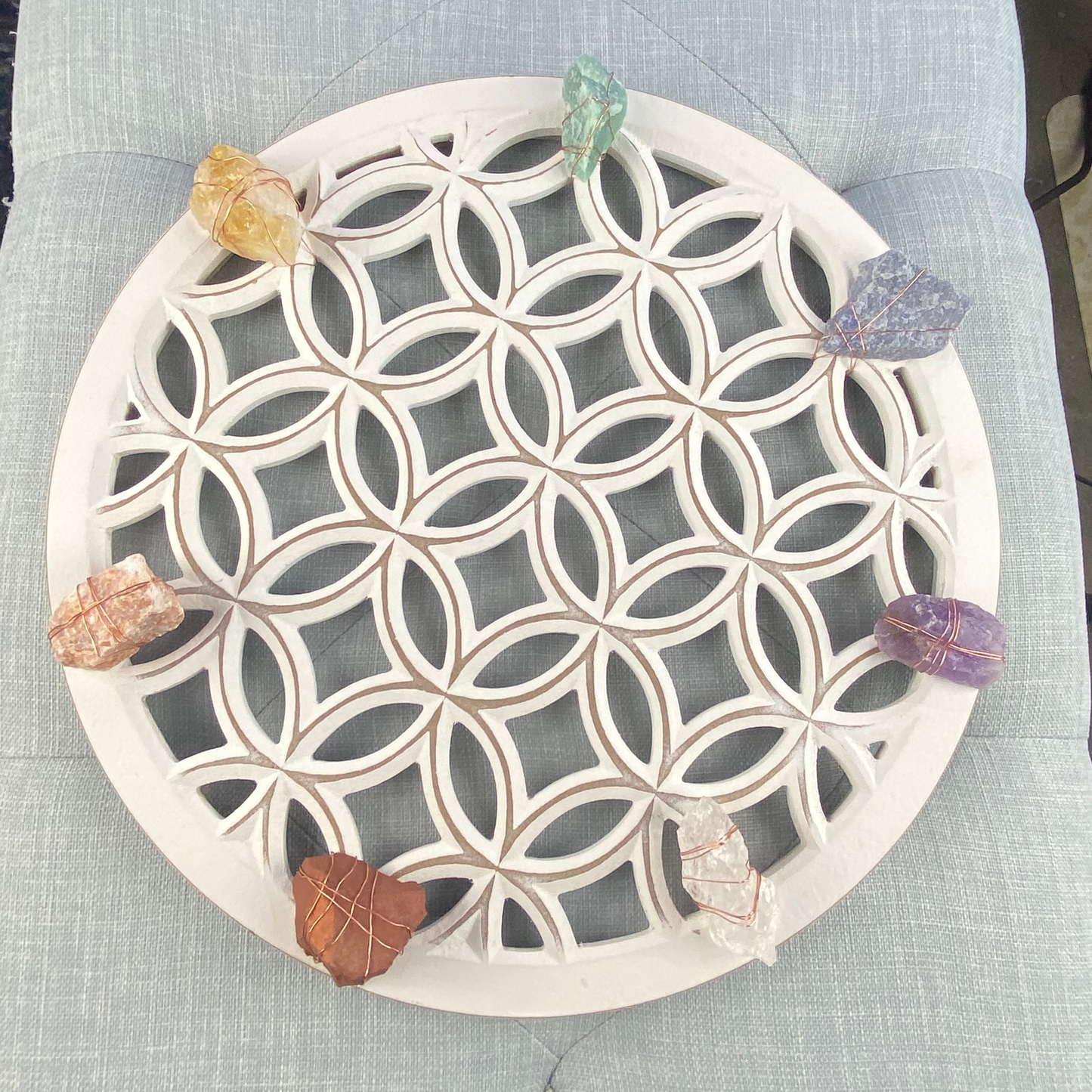 Decorative stone coaster with geometric pattern on a textured surface