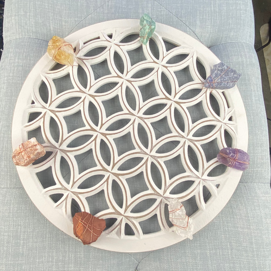 Decorative stone coaster with geometric pattern on a textured surface