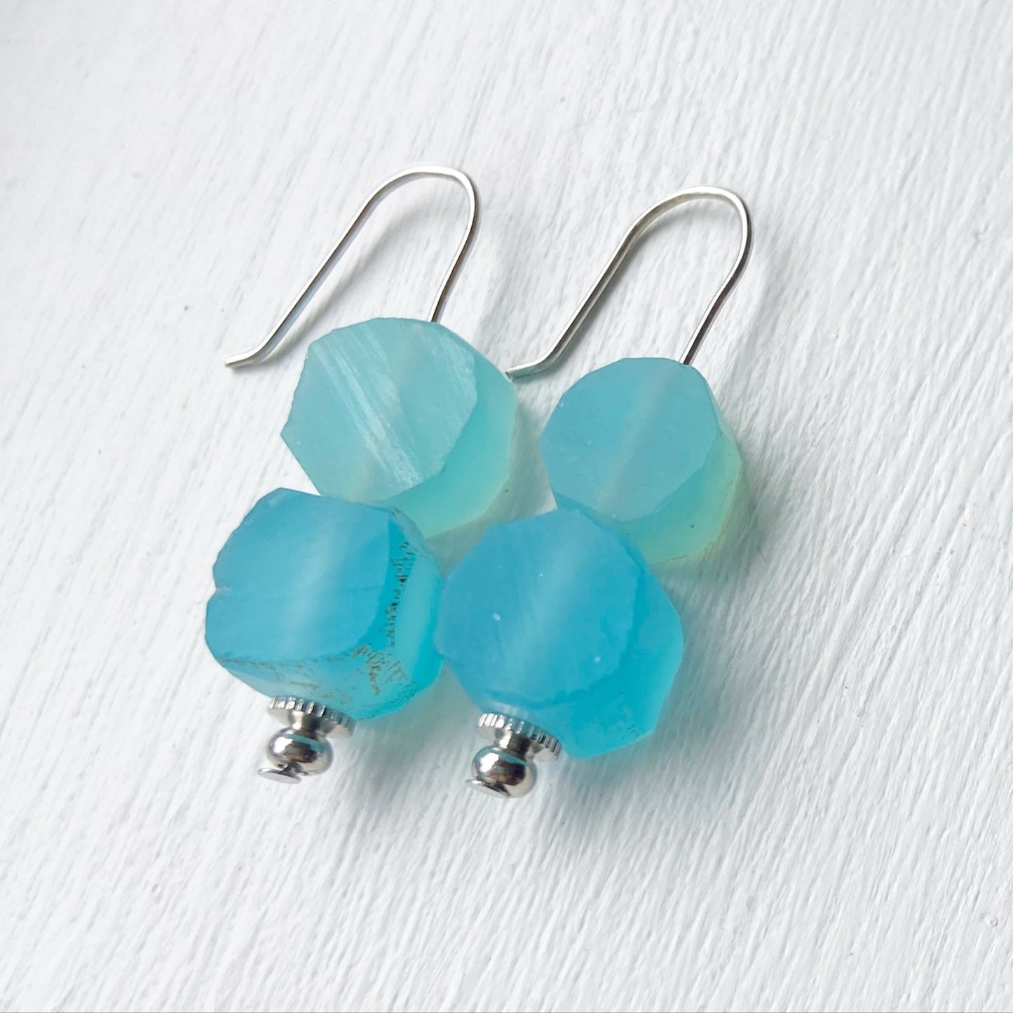 Blue earrings on a white background