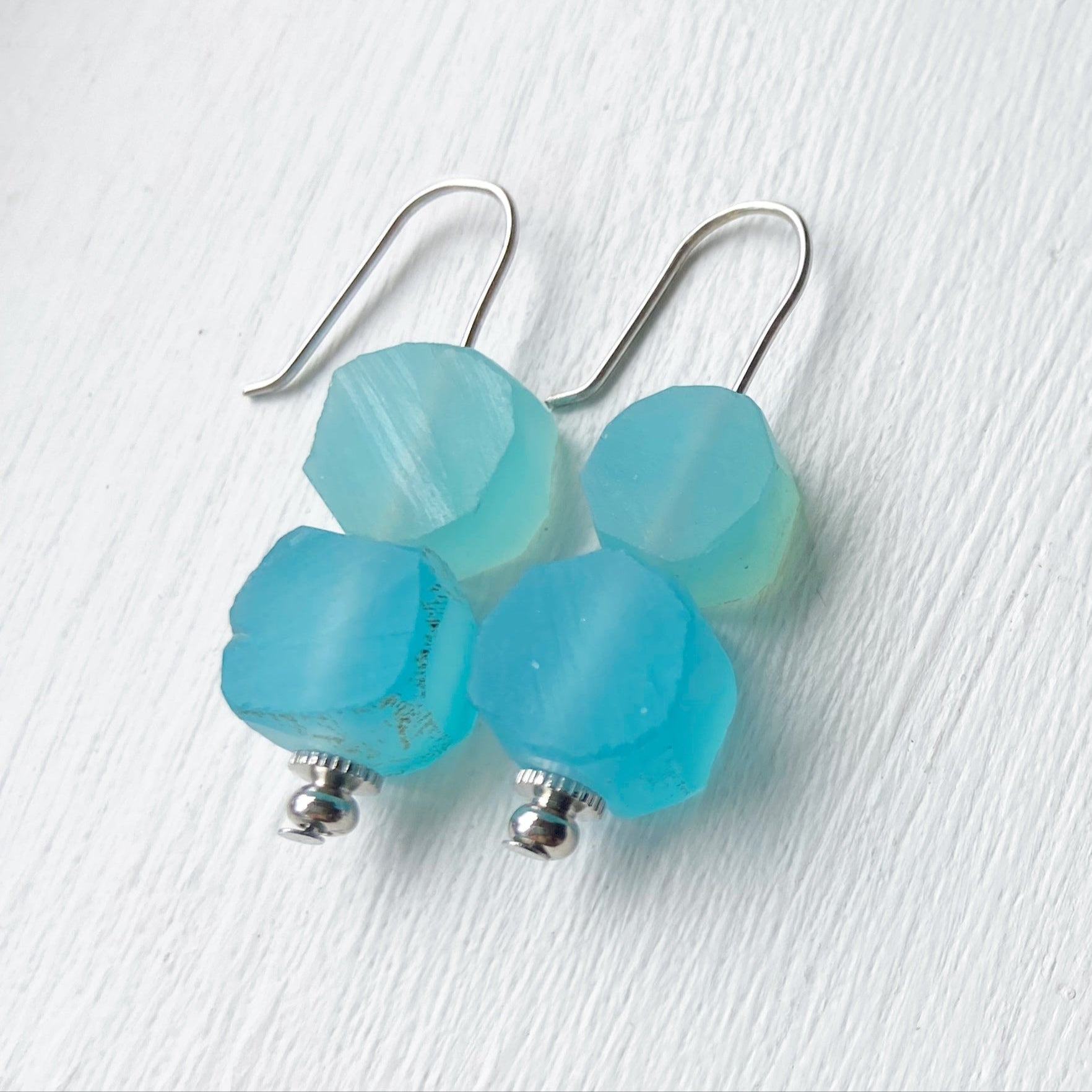 Blue earrings on a white background