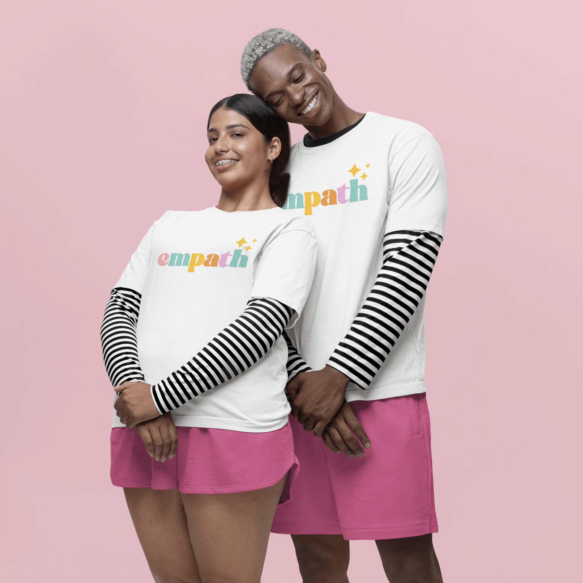 Two people wearing matching outfits with 'empath' text on a pink background
