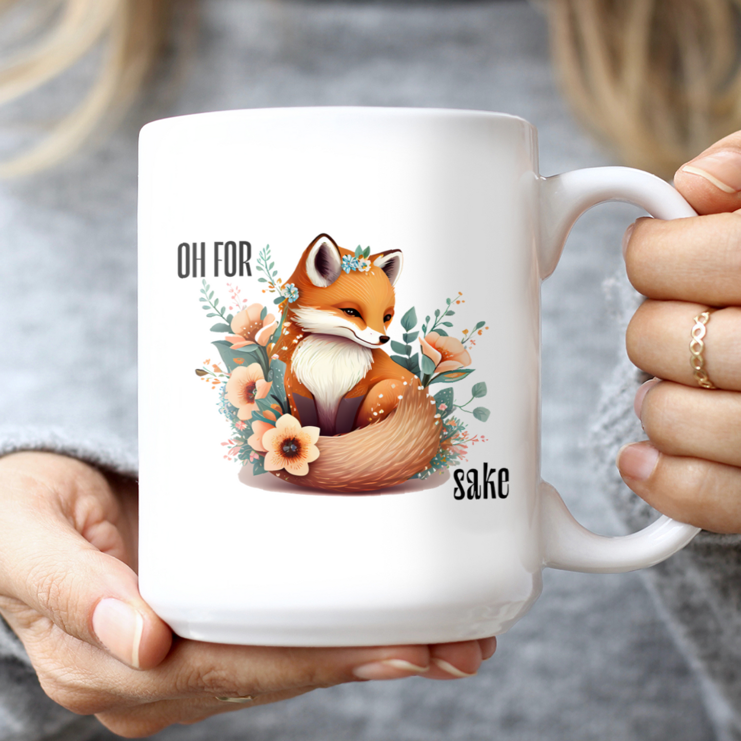 Woman holding White Oh For Fox Sake Sarcastic Cute Mug, 15oz with fox with a bushy tail and peach flowers around it