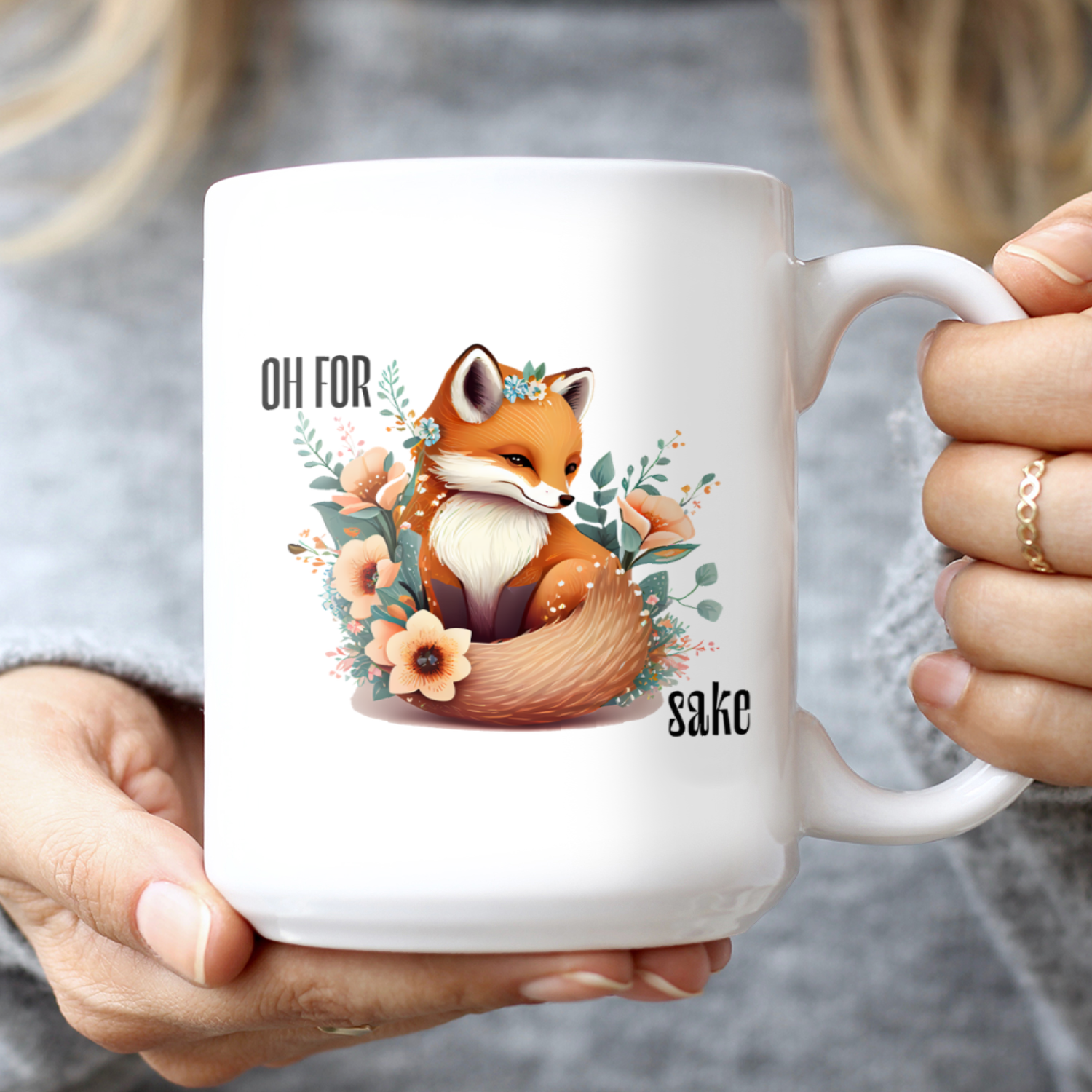 Woman holding White Oh For Fox Sake Sarcastic Cute Mug, 15oz with fox with a bushy tail and peach flowers around it